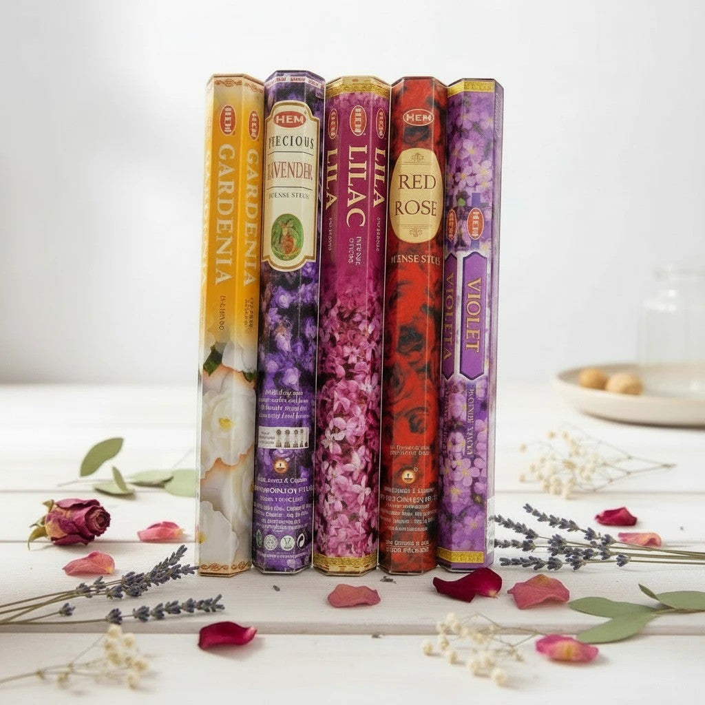 The Witches' Quest HEM floral incense variety pack featuring five hexagonal boxes of gardenia, lavender, lilac, rose, and violet scents.