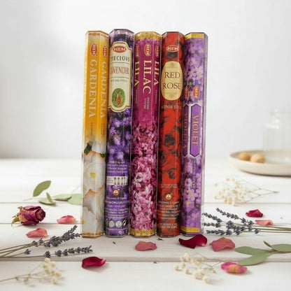 The Witches' Quest HEM floral incense variety pack featuring five hexagonal boxes of gardenia, lavender, lilac, rose, and violet scents.