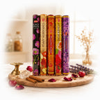 The Witches' Quest HEM incense variety pack featuring five scented stick boxes on a wooden board with ritual items.