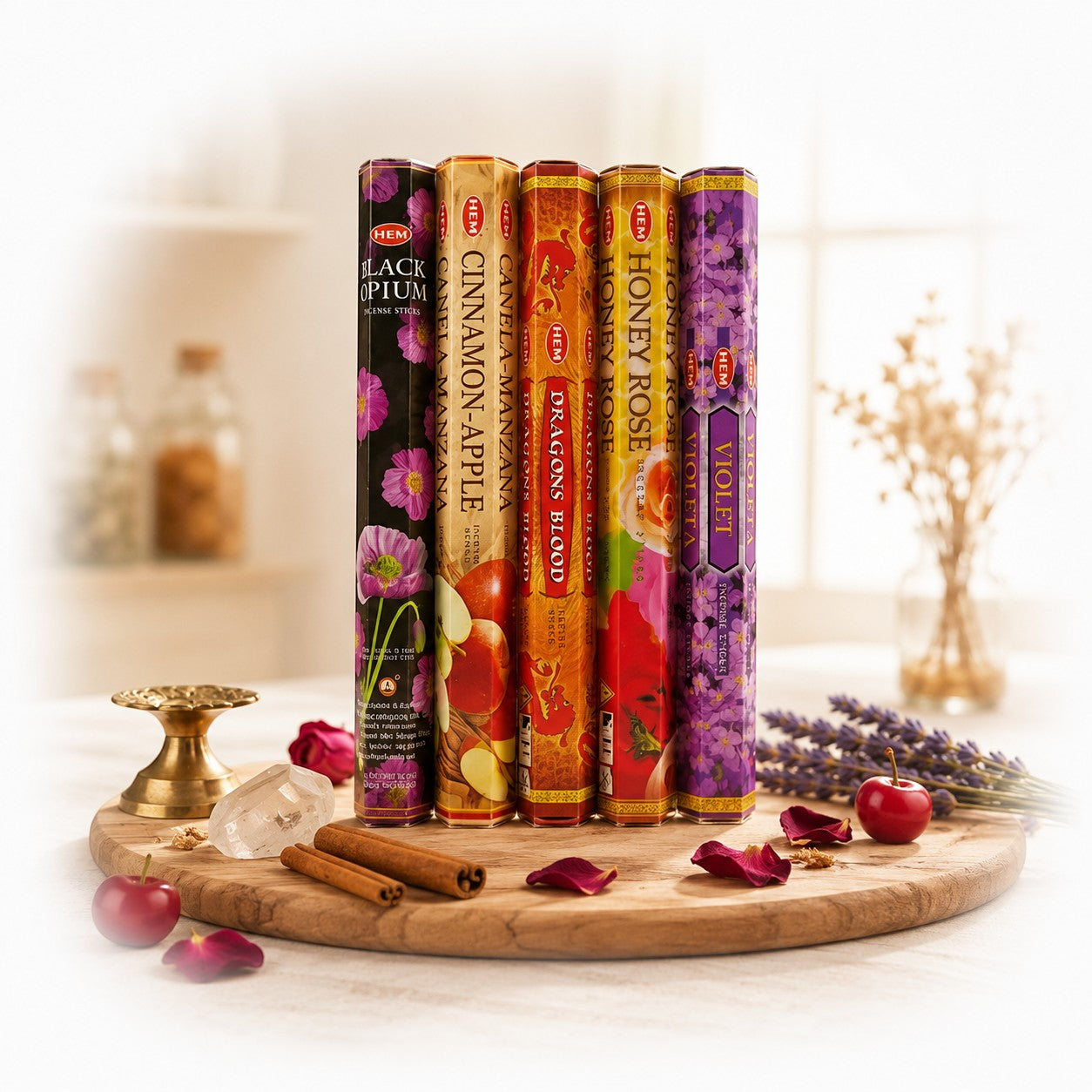 The Witches' Quest HEM incense variety pack featuring five scented stick boxes on a wooden board with ritual items.