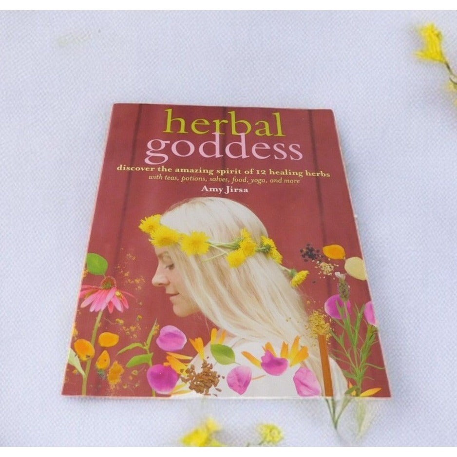 The Witches' Quest Herbal Goddess softcover book by Amy Jirsa featuring a woman with a yellow flower crown