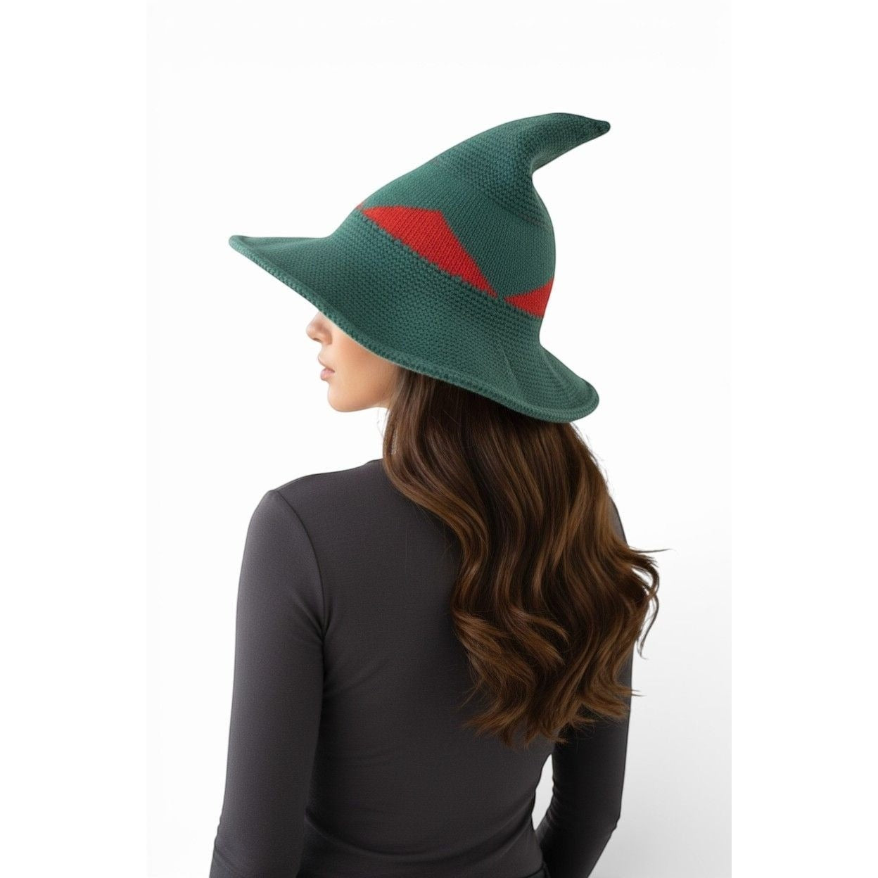 The Witches' Quest green and red color block knitted witch hat with a wide brim and pointed tip worn by a woman.