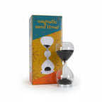 The Witches' Quest magnetic sand timer with black iron filings forming stalagmites in a clear glass hourglass.