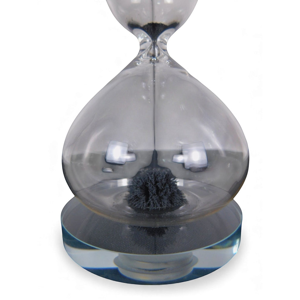 The Witches' Quest magnetic hourglass with black iron filings forming a stalagmite shape inside clear glass.