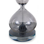 The Witches' Quest magnetic hourglass with black iron filings forming a stalagmite shape inside clear glass.