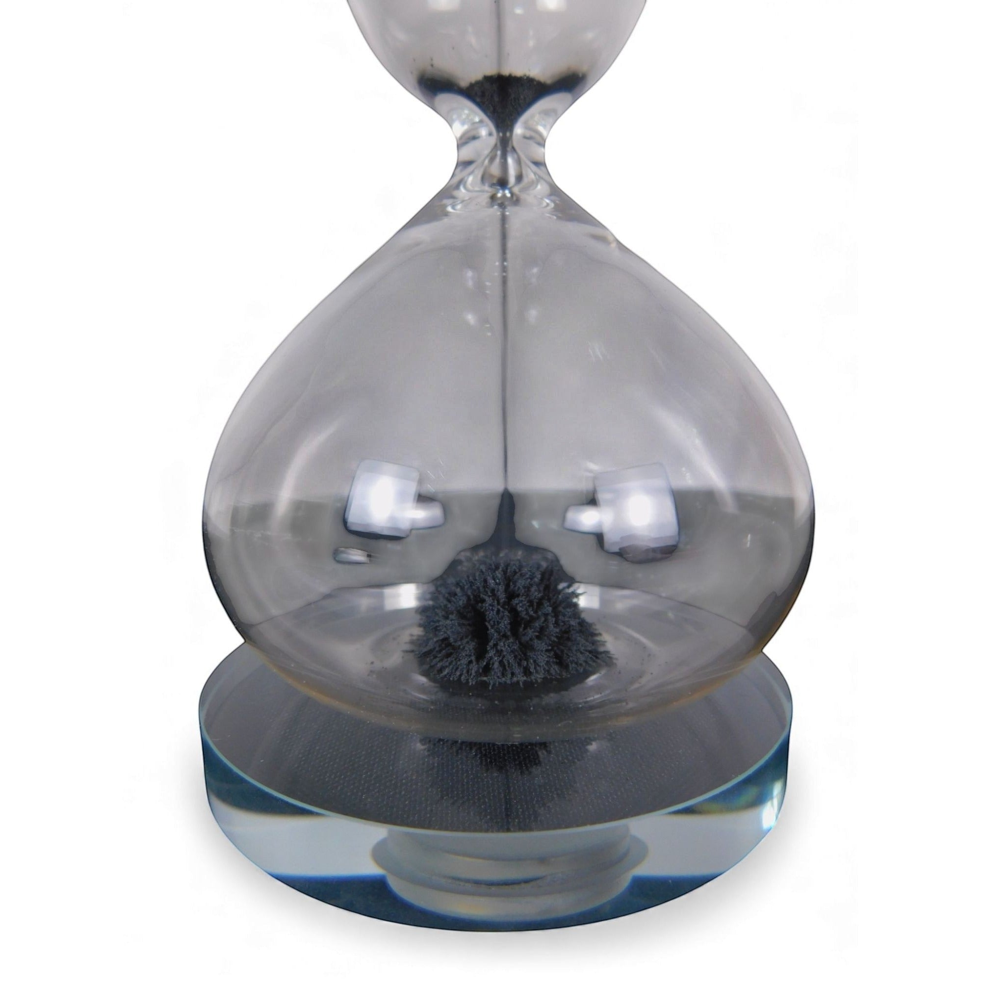 The Witches' Quest magnetic hourglass with black iron filings forming a stalagmite shape inside clear glass.