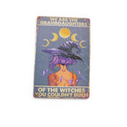 The Witches' Quest metal sign featuring a purple-haired witch, moon phases, and empowering text on a vintage background.