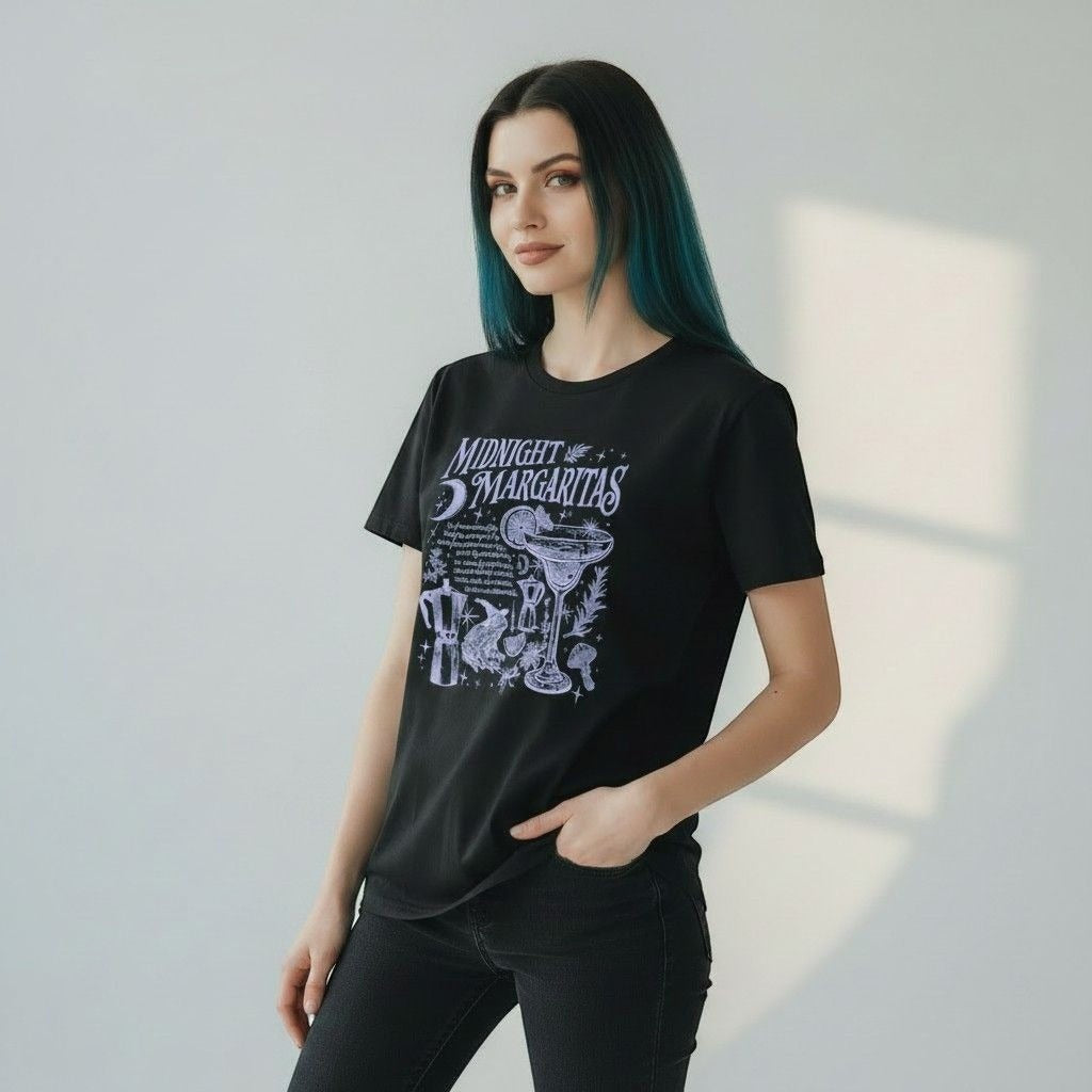 The Witches' Quest black cotton crewneck t-shirt featuring a white Midnight Margaritas celestial cocktail graphic.