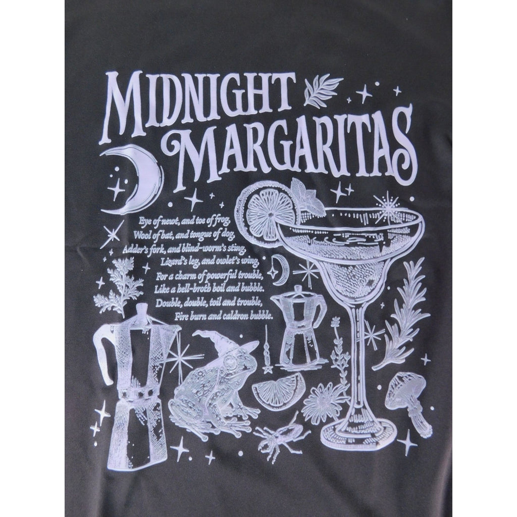 The Witches' Quest black cotton crewneck t-shirt featuring a white graphic of a margarita, frog, and occult motifs.