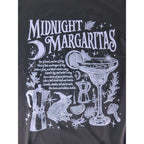 The Witches' Quest black cotton crewneck t-shirt featuring a white graphic of a margarita, frog, and occult motifs.