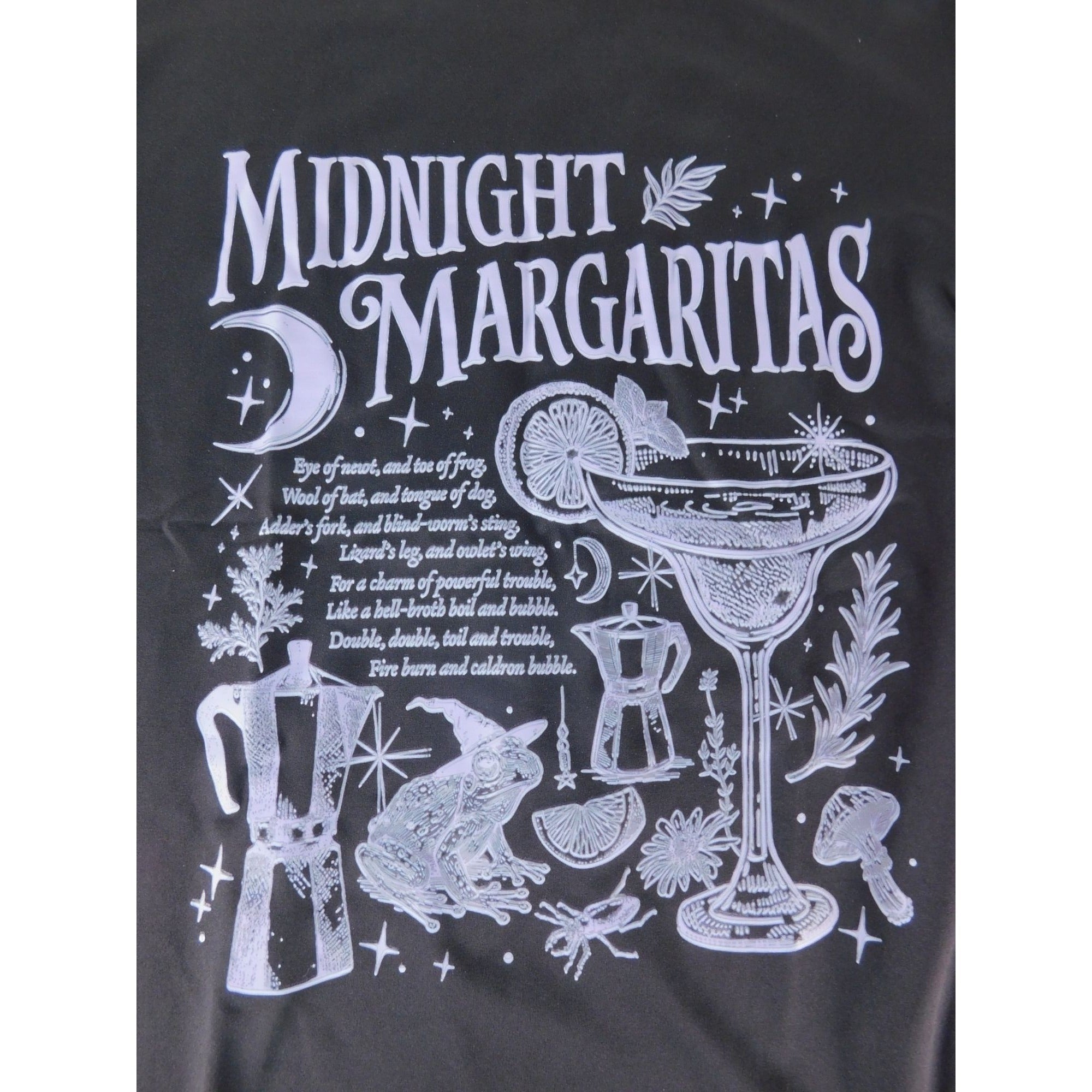 The Witches' Quest black cotton crewneck t-shirt featuring a white graphic of a margarita, frog, and occult motifs.