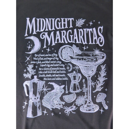 The Witches' Quest black cotton crewneck t-shirt featuring a white graphic of a margarita, frog, and occult motifs.