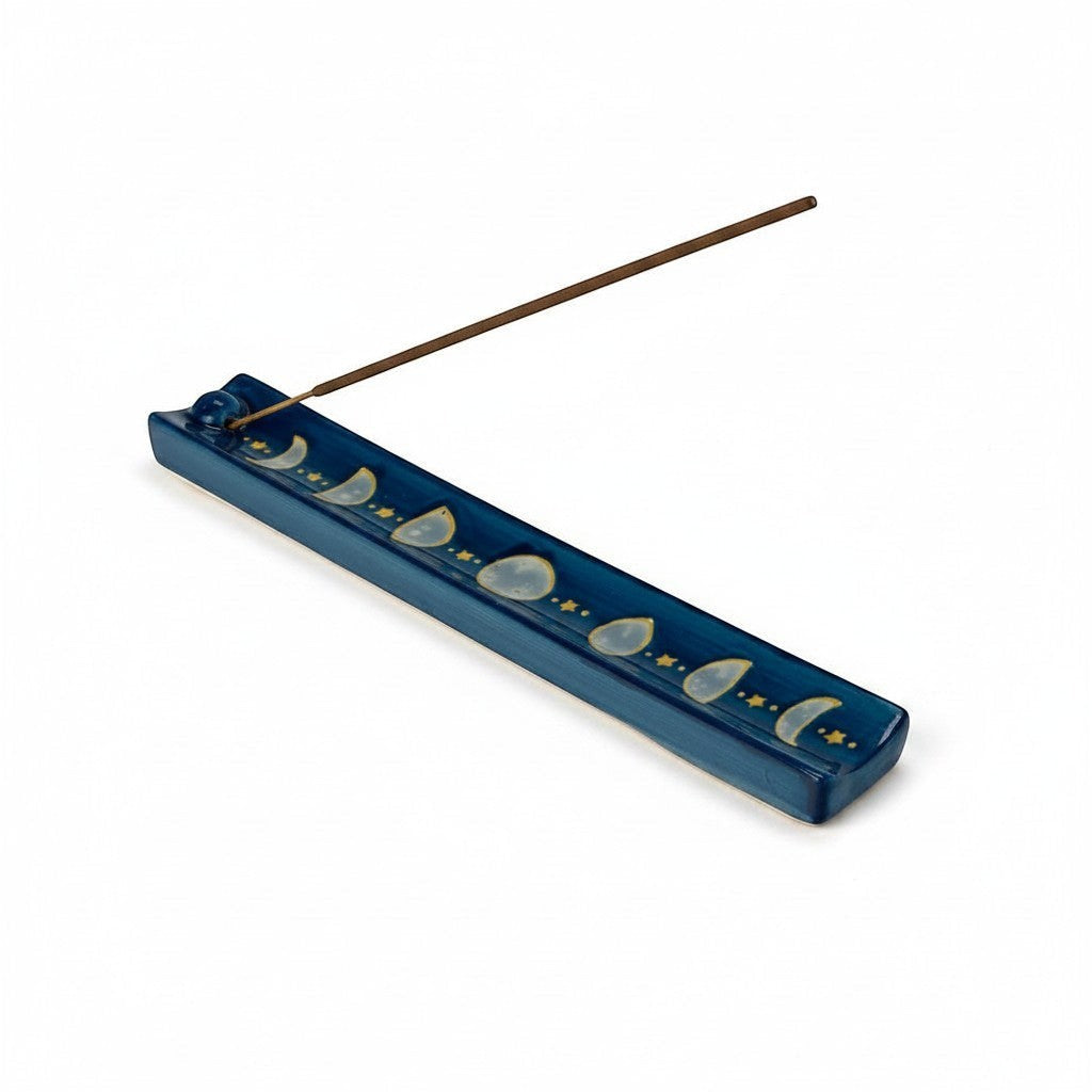 The Witches' Quest midnight blue ceramic incense stick holder featuring a hand-painted moon phase and golden stars.