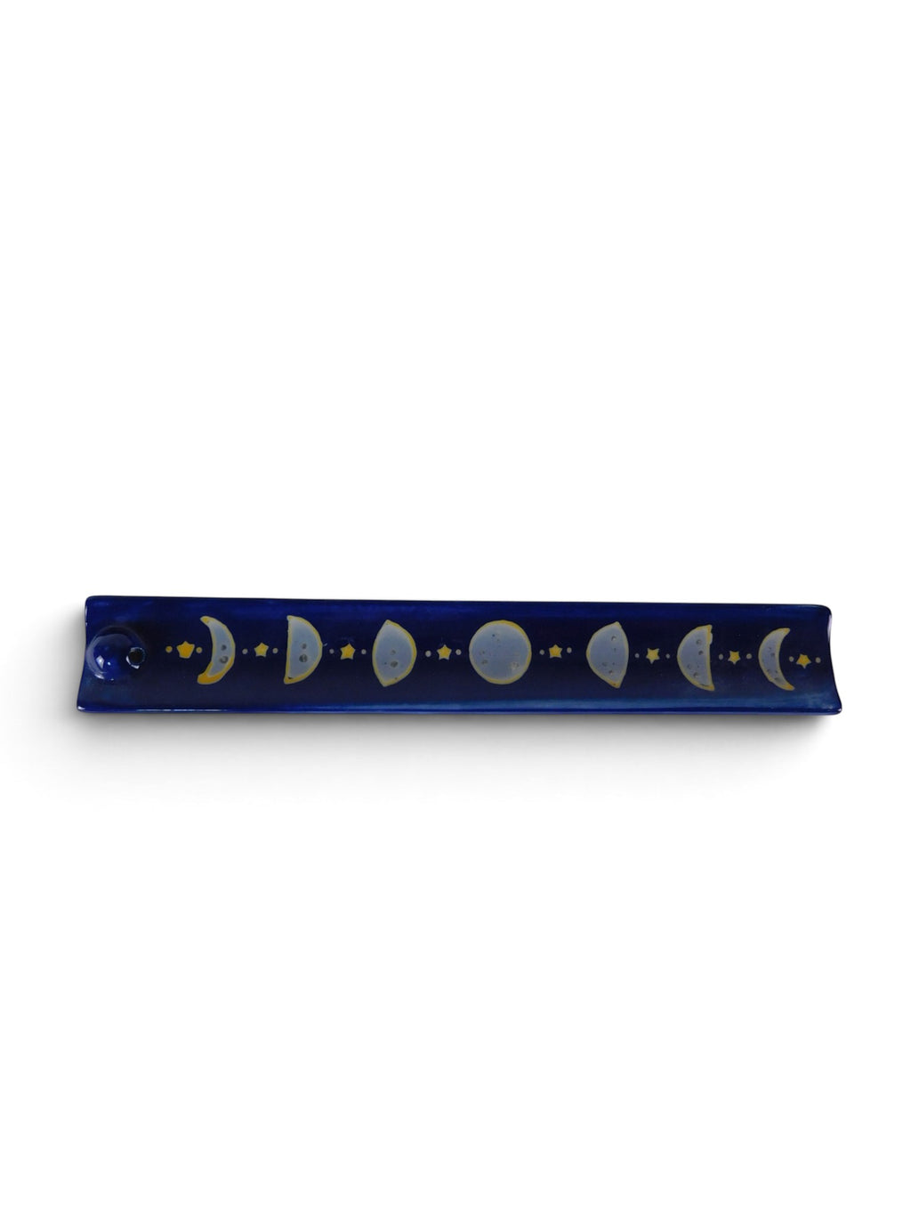 The Witches' Quest midnight blue ceramic incense stick holder with hand-painted moon phase cycle and golden stars.