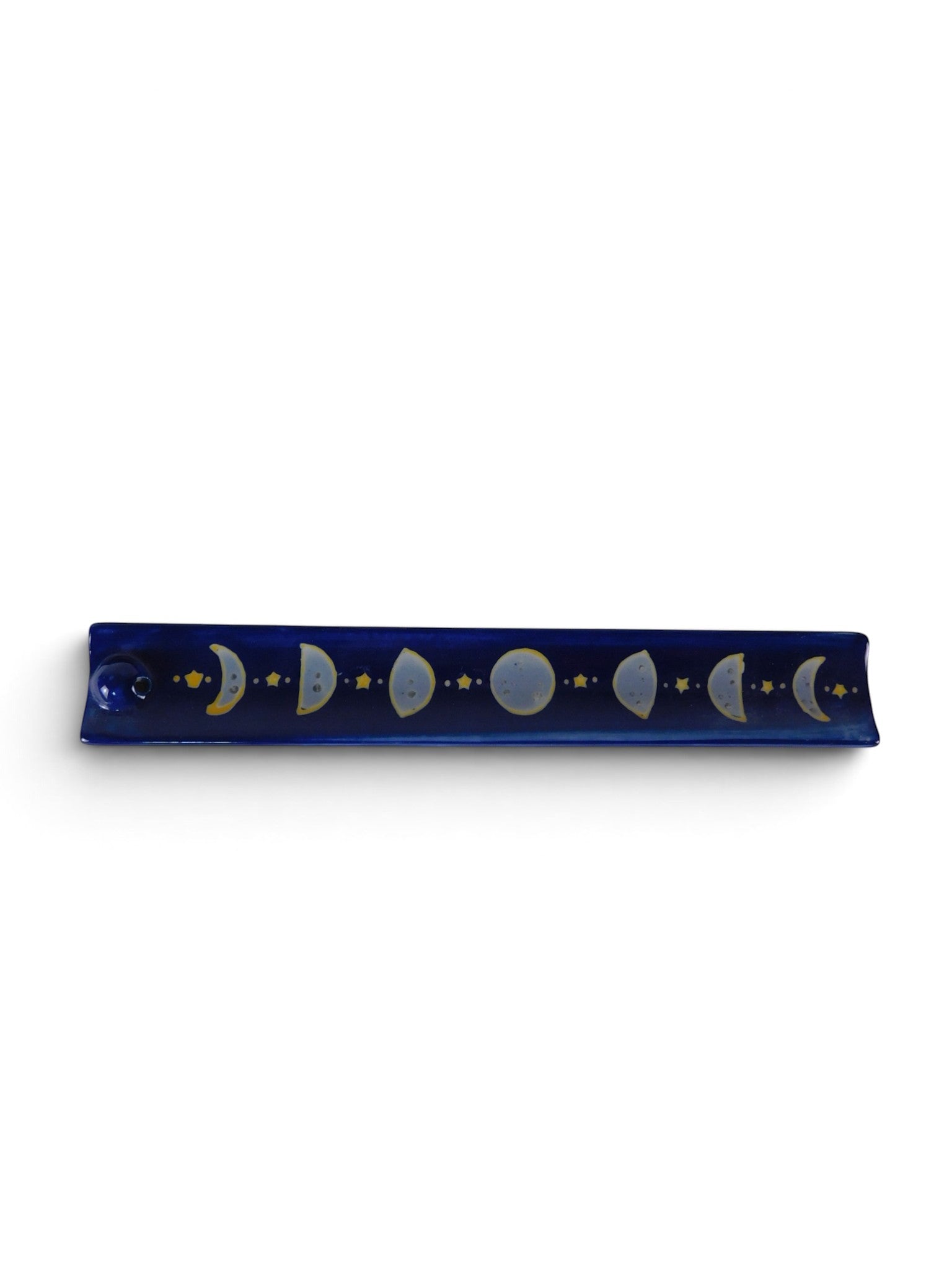 The Witches' Quest midnight blue ceramic incense stick holder with hand-painted moon phase cycle and golden stars.