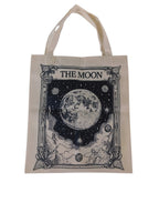 The Witches' Quest canvas tote bag featuring a detailed black and white illustration of The Moon tarot card design.