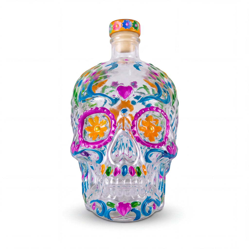 The Witches' Quest clear glass skull decanter with vibrant hand-painted floral and heart designs for altar decor.