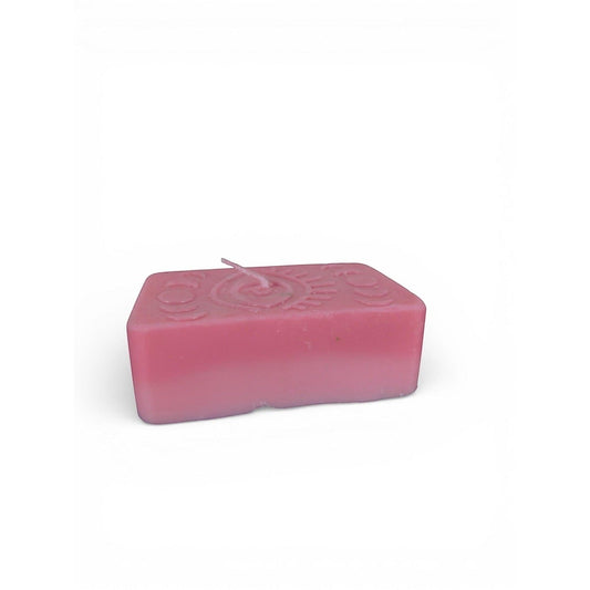 The Witches' Quest handmade pink rectangular wax candle with embossed mystical eye and moon phase design.