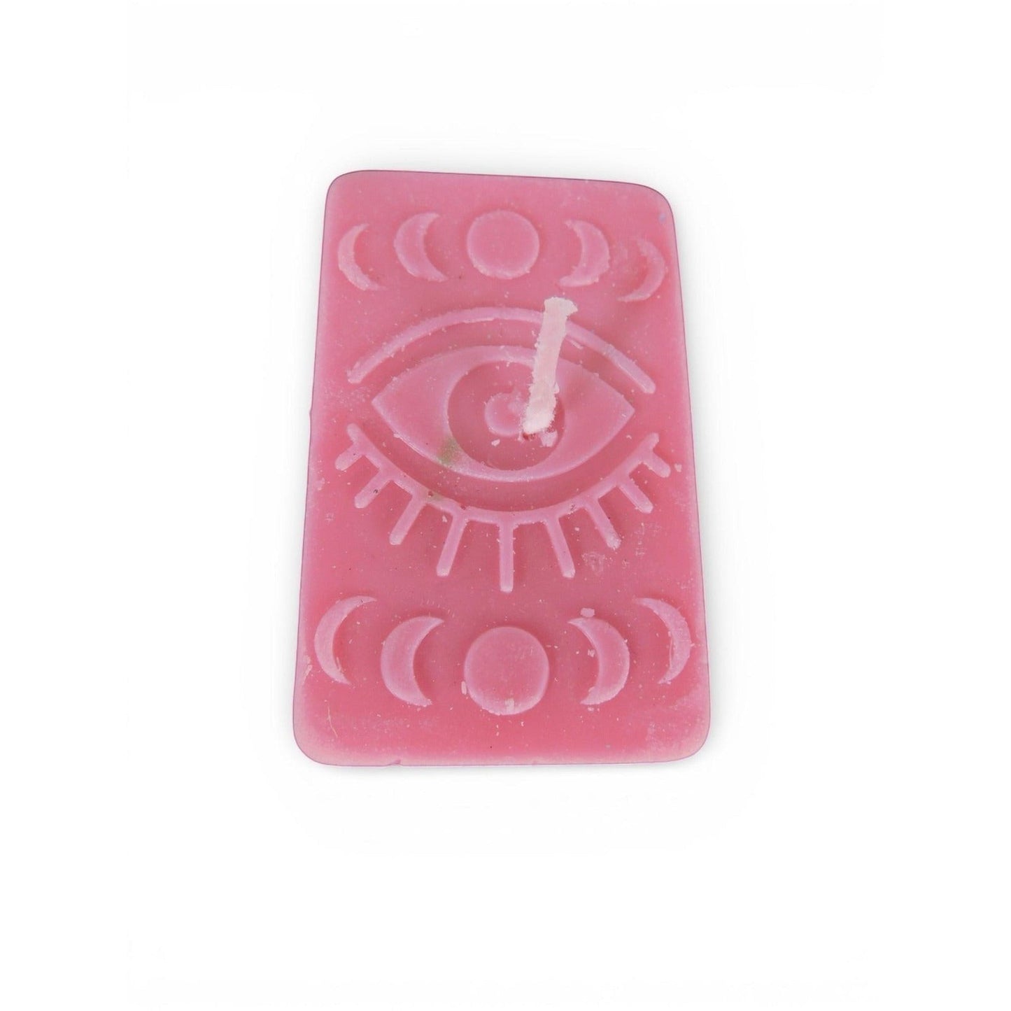 The Witches' Quest handmade pink rectangular candle with embossed mystical eye and moon phase celestial design.
