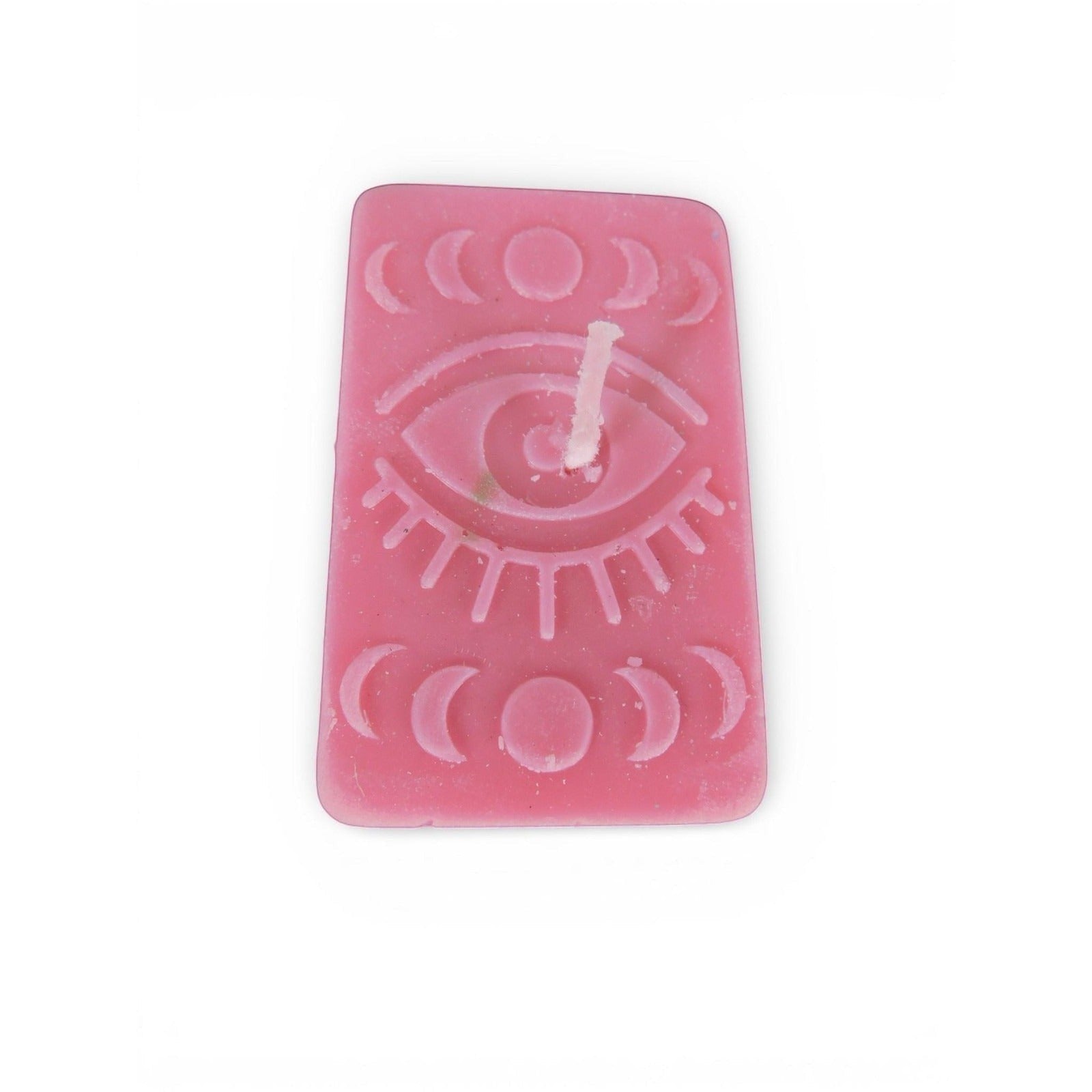 The Witches' Quest handmade pink rectangular candle with embossed mystical eye and moon phase celestial design.