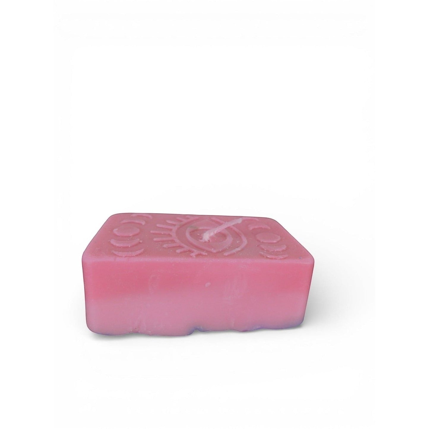 The Witches' Quest handmade pink rectangular wax candle with embossed mystical eye and moon phase design.