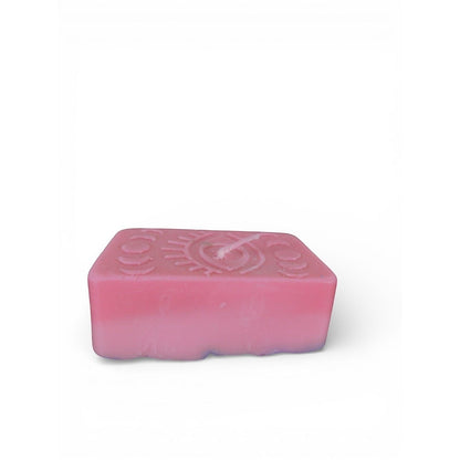 The Witches' Quest handmade pink rectangular wax candle with embossed mystical eye and moon phase design.