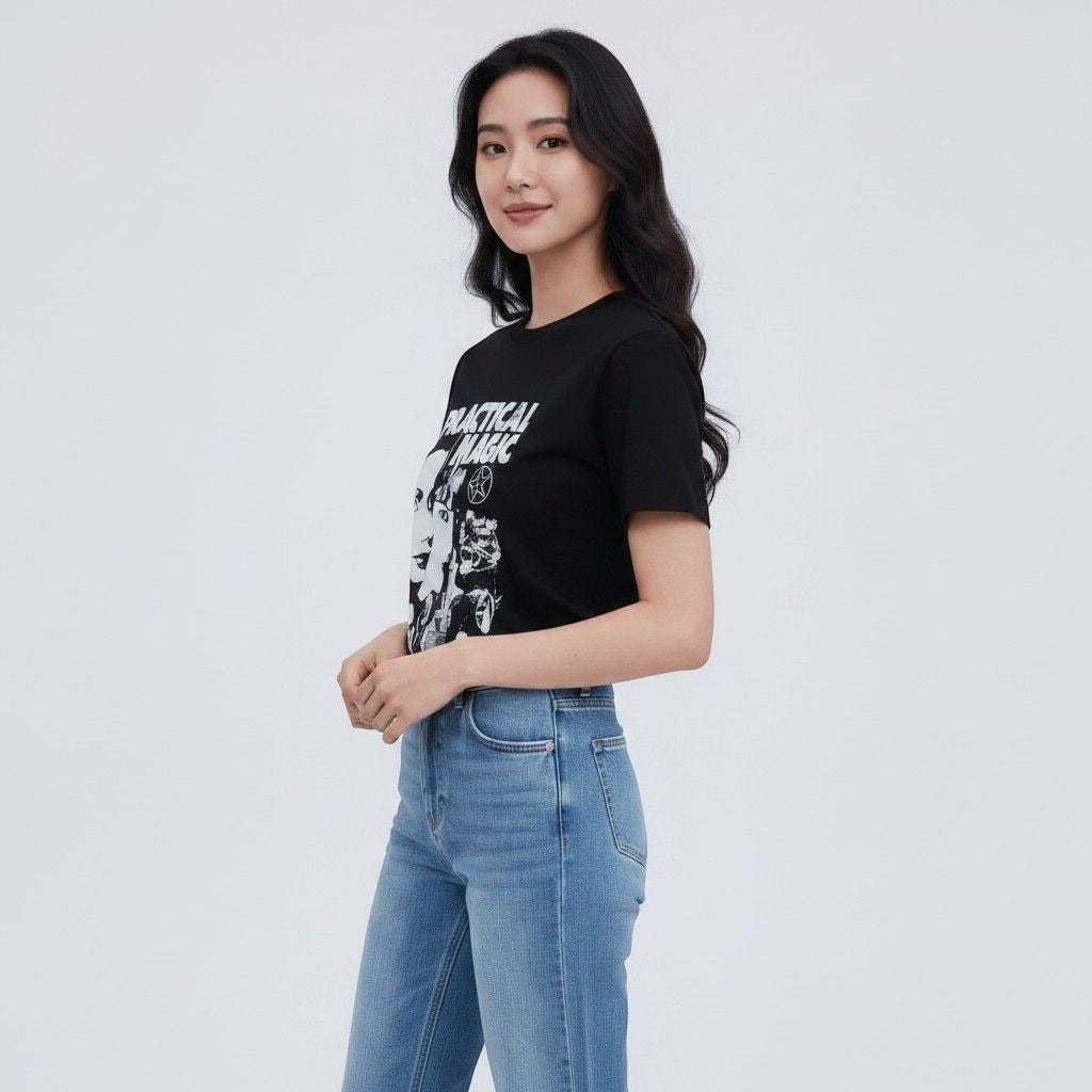 The Witches' Quest black cotton crewneck t-shirt with Practical Magic graphic print worn by a woman with blue jeans.