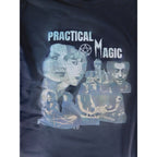 The Witches' Quest black cotton crewneck t-shirt featuring a vintage-inspired Practical Magic movie collage graphic.