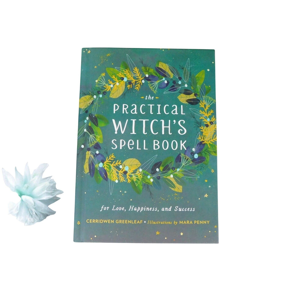 The Witches' Quest The Practical Witch's Spell Book hardcover with green botanical cover and gold star illustrations.