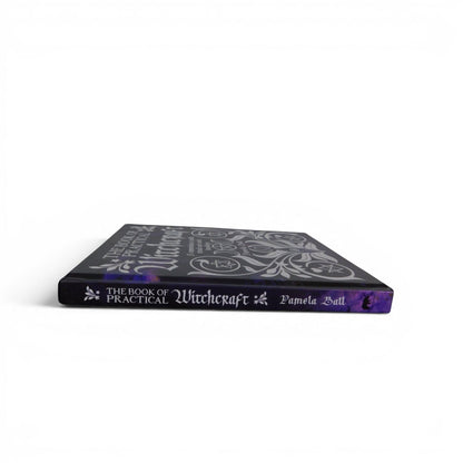 The Witches' Quest The Book of Practical Witchcraft hardcover book with silver mystical symbols on a black cover