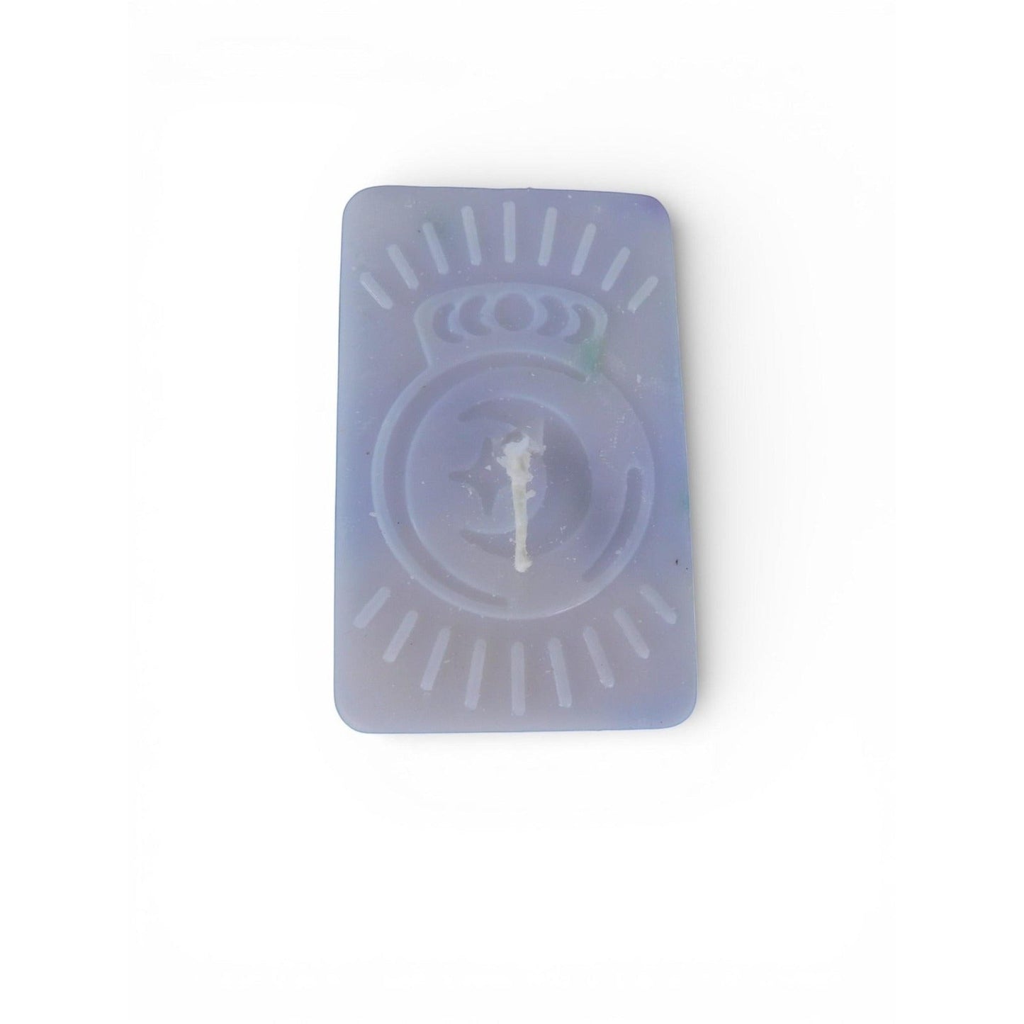 The Witches' Quest handmade purple rectangular wax candle with an embossed celestial moon and sun ray emblem.