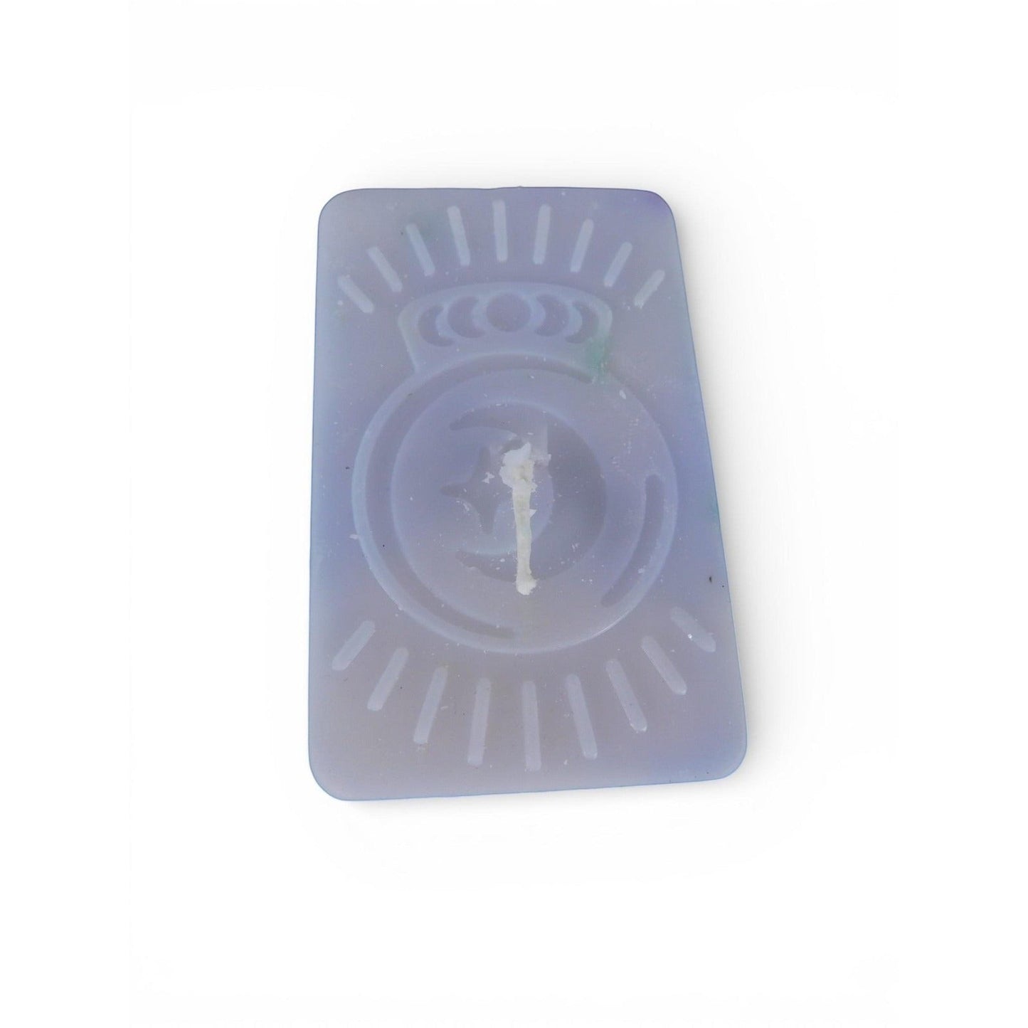 The Witches' Quest handmade purple rectangular wax candle with an embossed celestial moon and sun ray emblem.