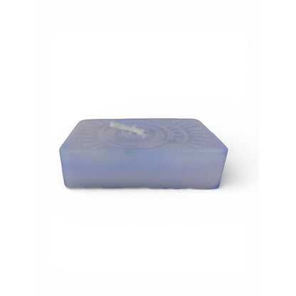 The Witches' Quest handmade purple rectangular wax candle with an embossed celestial moon and sun ray emblem.