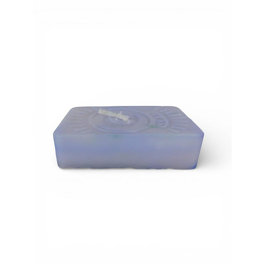 The Witches' Quest handmade purple rectangular wax candle with an embossed celestial moon and sun ray emblem.