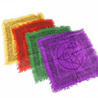 The Witches' Quest set of 4 rainbow altar cloths with black triquetra and Celtic knot prints and fringed edges.