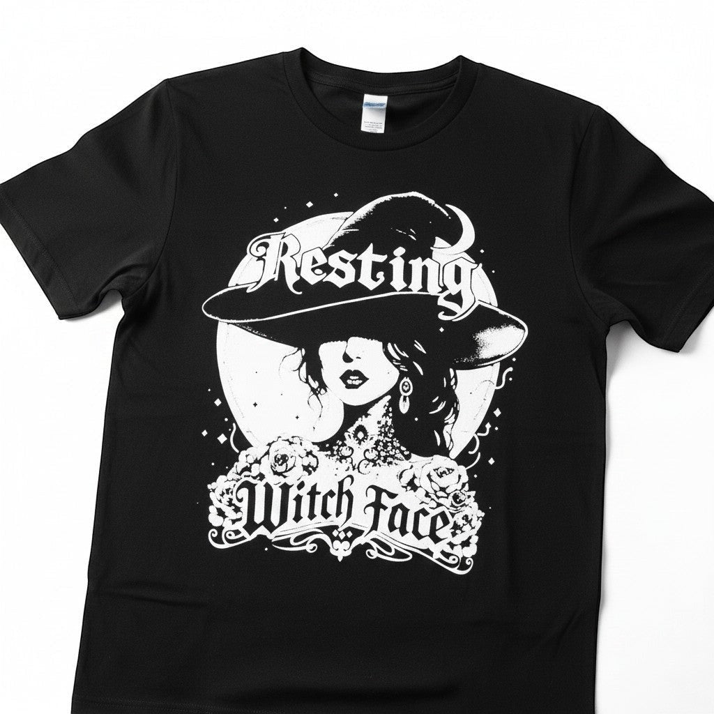 The Witches' Quest black cotton crew neck t-shirt featuring a white Resting Witch Face graphic with a moon design.