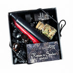 The Witches' Quest Return to Sender ritual kit with black and red candles, herb blend, crystals, and spell card.
