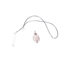 The Witches' Quest rose quartz teardrop pendant with copper wire wrapped tree of life design on a black cord necklace.