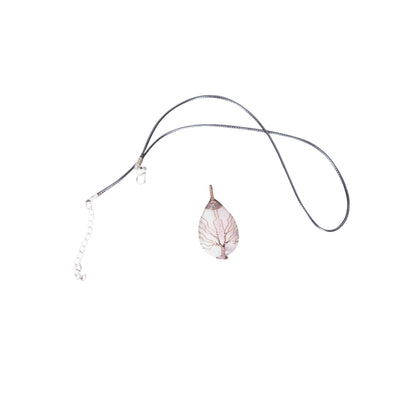 The Witches' Quest rose quartz teardrop pendant with copper wire wrapped tree of life design on a black cord necklace.