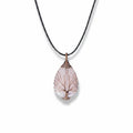 The Witches' Quest rose quartz teardrop pendant necklace with a copper wire wrapped tree of life design on a black cord