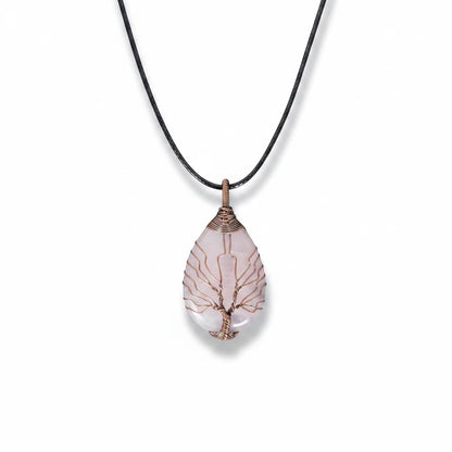 The Witches' Quest rose quartz teardrop pendant necklace with a copper wire wrapped tree of life design on a black cord