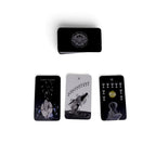 The Witches' Quest The Sacred Web tarot cards featuring dark charcoal backgrounds with mystical white illustrations