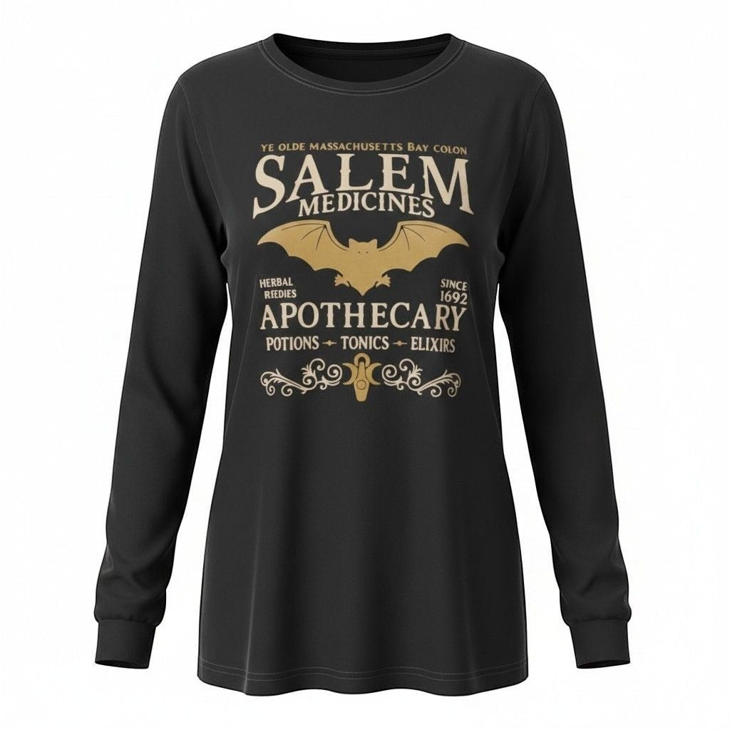 The Witches' Quest black long sleeve crewneck shirt featuring a gold Salem Apothecary graphic with a bat and scrollwork.