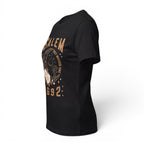 The Witches' Quest black cotton unisex t-shirt featuring a Salem 1692 celestial cat and floral graphic print.