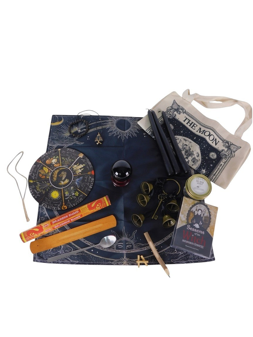 The Witches' Quest Samhain altar bundle featuring a celestial cloth, oracle deck, obsidian sphere, bells, and ritual tools.