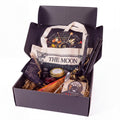 The Witches' Quest Samhain altar bundle in a box with oracle deck, obsidian, ritual tools, and moon tote bag.