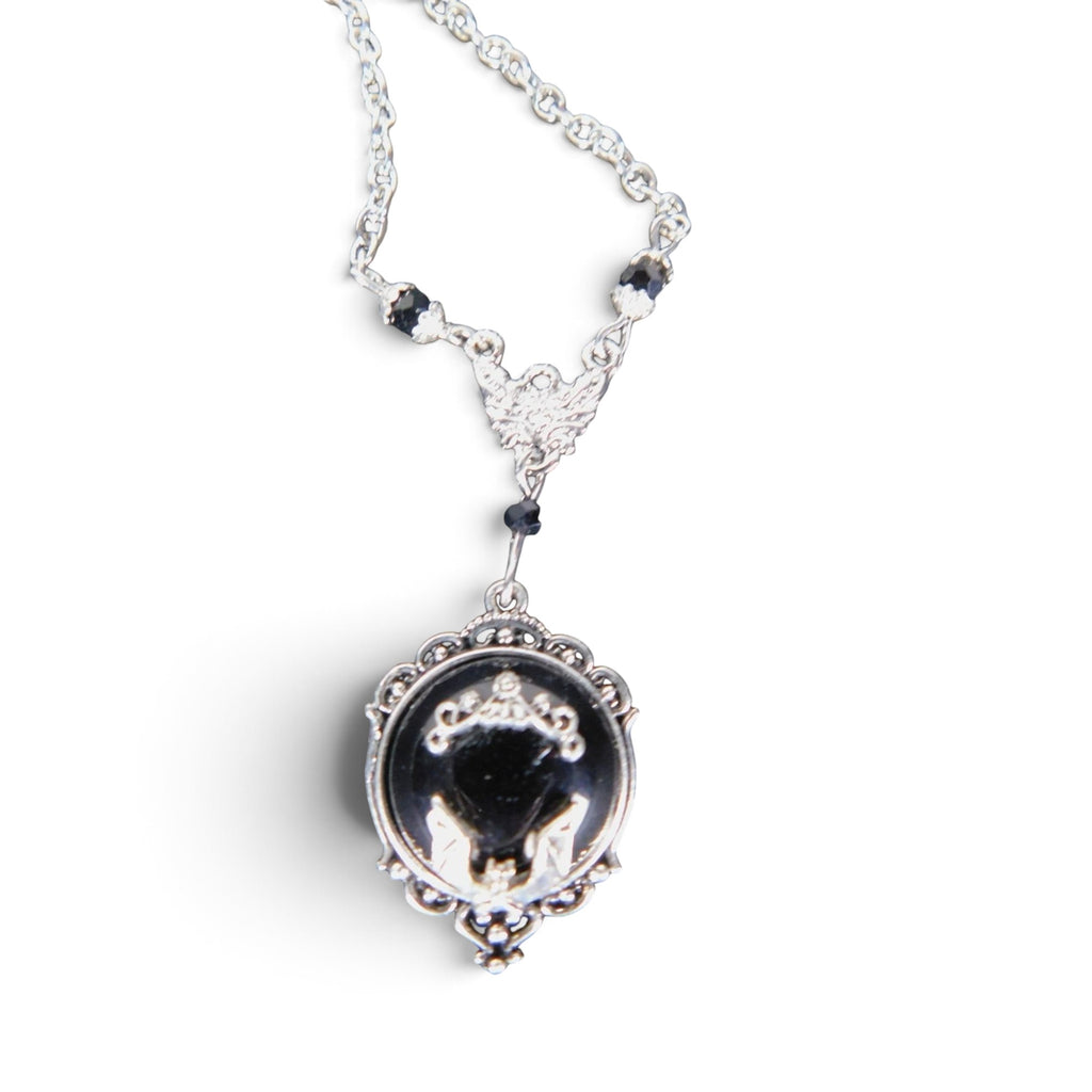 The Witches' Quest Victorian gothic necklace with a silver bat cameo on a black resin oval pendant and ornate frame.