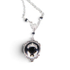 The Witches' Quest Victorian gothic necklace with a silver bat cameo on a black resin oval pendant and ornate frame.