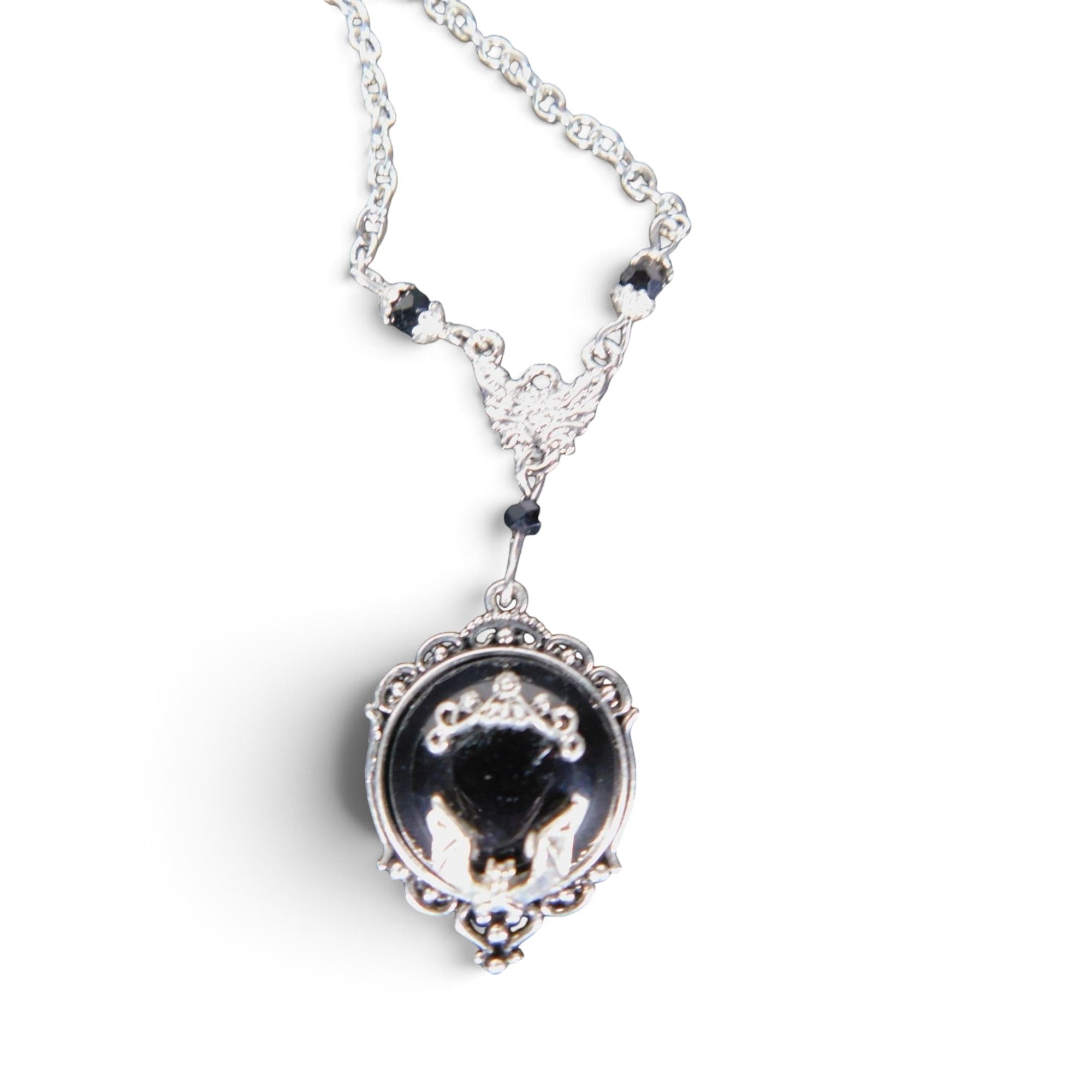 The Witches' Quest Victorian gothic necklace with a silver bat cameo on a black resin oval pendant and ornate frame.