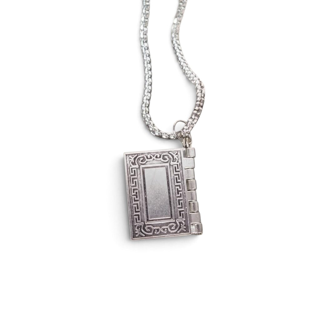 The Witches' Quest silver-tone rectangular Bible locket pendant necklace with ornate border on a 26-inch chain.